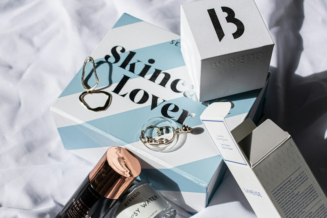 gold and silver round analog watch on white and blue box